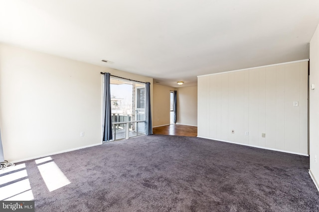 carpeted empty room with baseboards