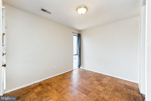 spare room with visible vents and baseboards