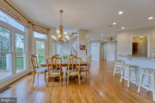 dining room featuring visible vents, light wood-type flooring, a notable chandelier, and recessed lighting