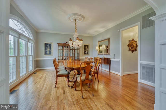 dining area featuring a notable chandelier, visible vents, and light wood-style flooring