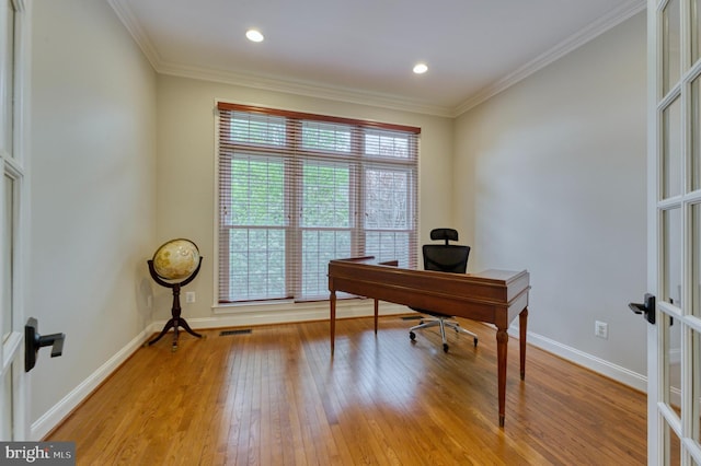 office with baseboards, ornamental molding, french doors, light wood-style floors, and visible vents