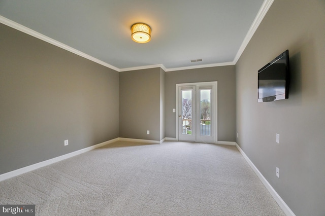 empty room with ornamental molding, baseboards, carpet, and visible vents