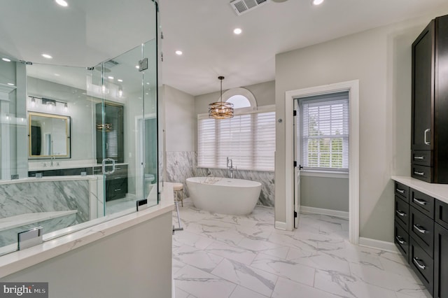 bathroom featuring a shower stall, a freestanding bath, marble finish floor, and visible vents