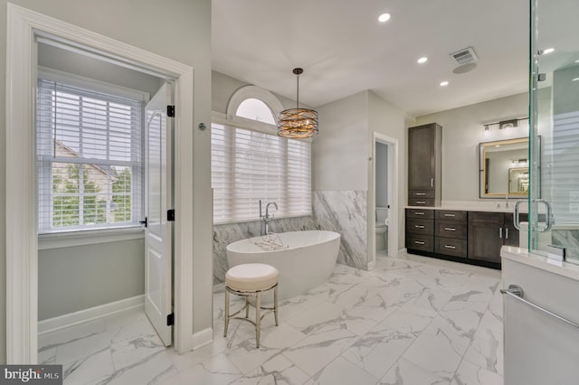 bathroom featuring a freestanding tub, vanity, visible vents, toilet, and marble finish floor