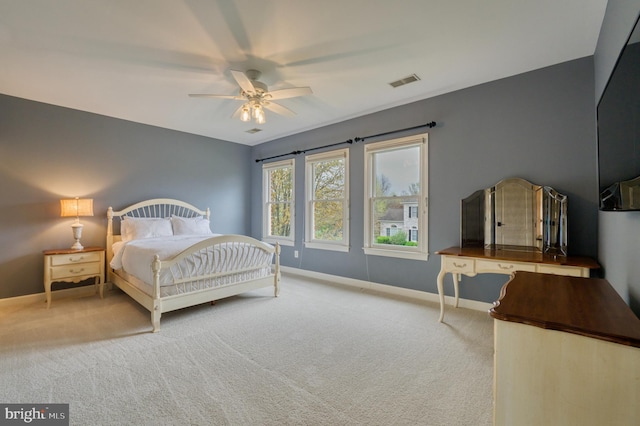 bedroom featuring ceiling fan, visible vents, baseboards, and carpet