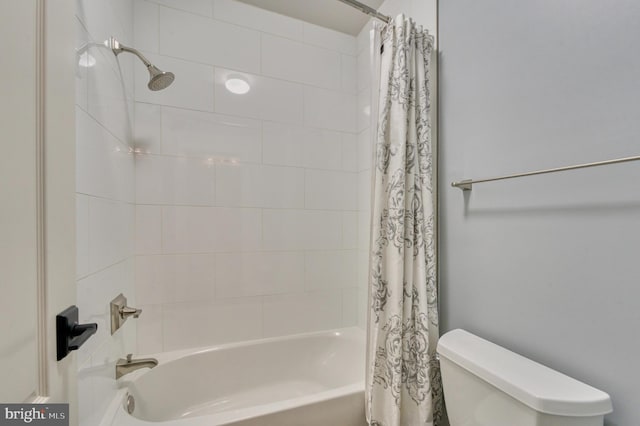 full bathroom featuring shower / tub combo and toilet