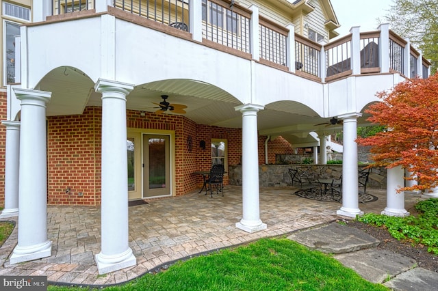 view of patio featuring a ceiling fan, outdoor dining area, and a balcony