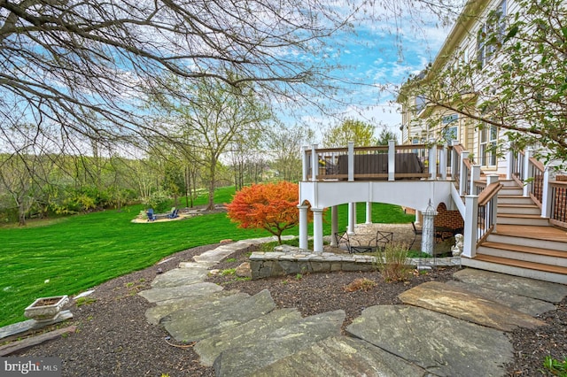 view of yard featuring a wooden deck and stairway