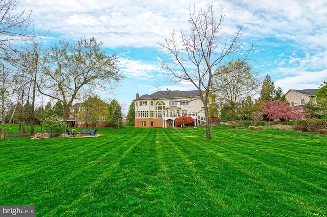 back of house with stairway, a wooden deck, and a lawn