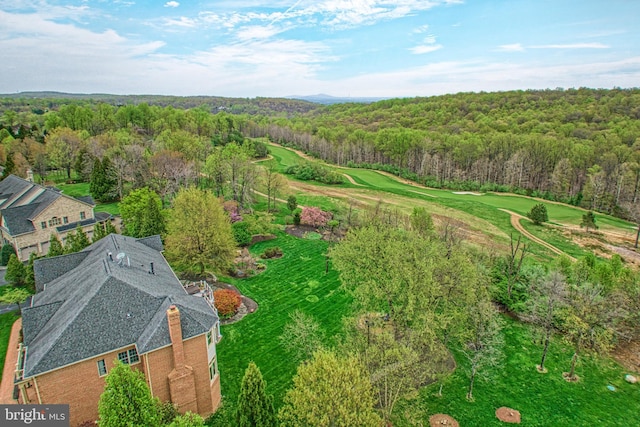 drone / aerial view featuring a view of trees and view of golf course
