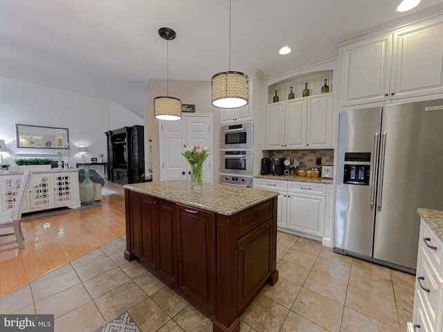 kitchen featuring appliances with stainless steel finishes, tasteful backsplash, white cabinets, and light tile patterned floors