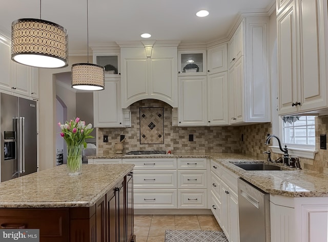 kitchen with light tile patterned floors, stainless steel appliances, a sink, white cabinetry, and backsplash