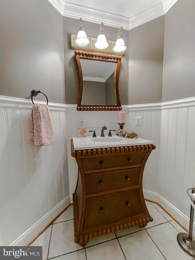 bathroom featuring a wainscoted wall, ornamental molding, vanity, and tile patterned floors