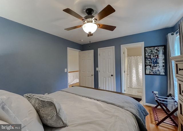 bedroom featuring ceiling fan, wood finished floors, connected bathroom, and baseboards