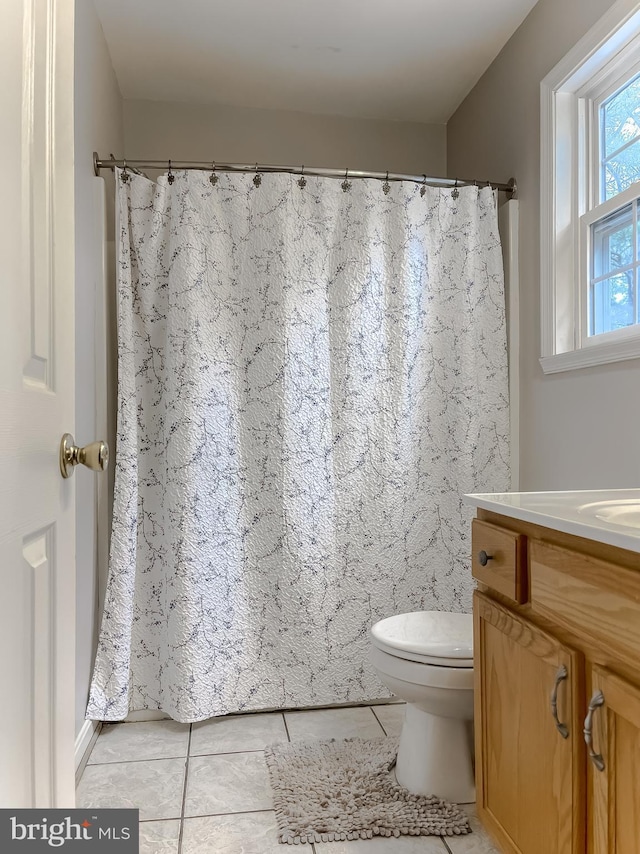 full bathroom with tile patterned flooring, a shower with curtain, vanity, and toilet