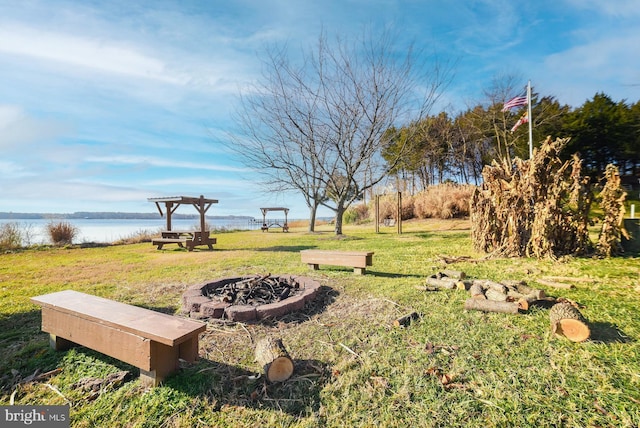 view of yard featuring an outdoor fire pit and a water view