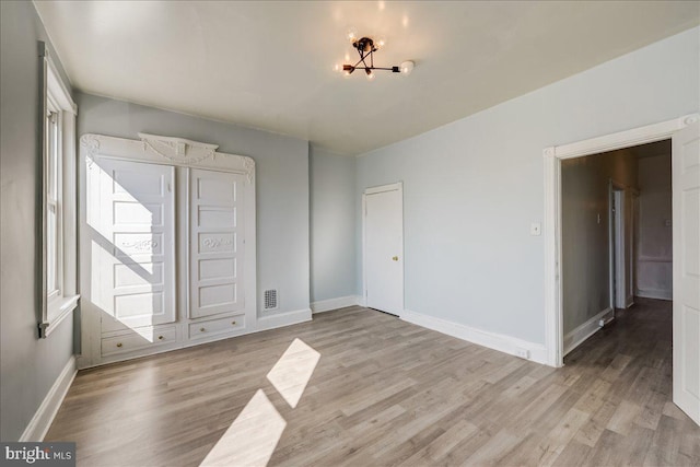 unfurnished bedroom featuring light wood-style flooring and baseboards