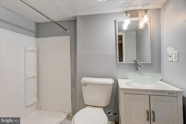 full bath with toilet, walk in shower, and vanity