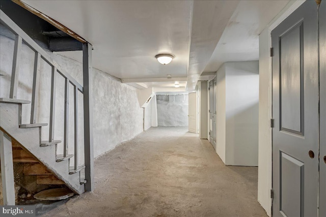 corridor with concrete floors and stairway