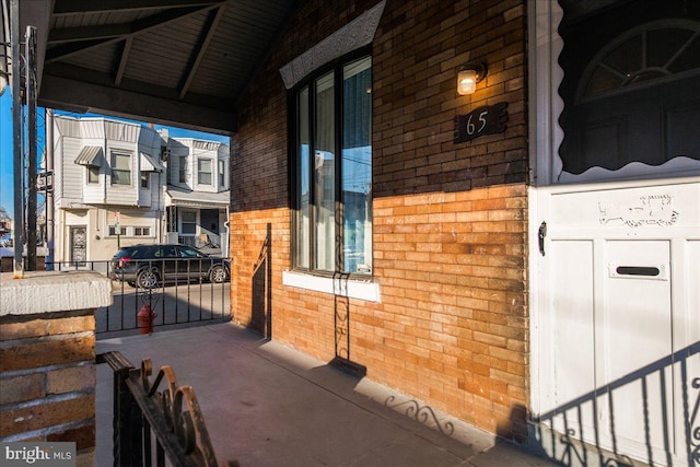 view of exterior entry with brick siding