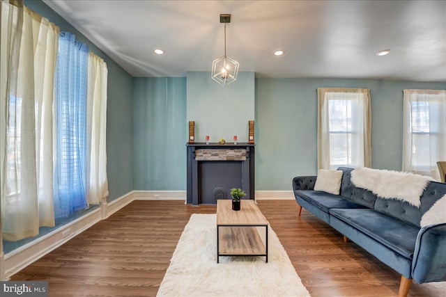 living room featuring recessed lighting, baseboards, and wood finished floors