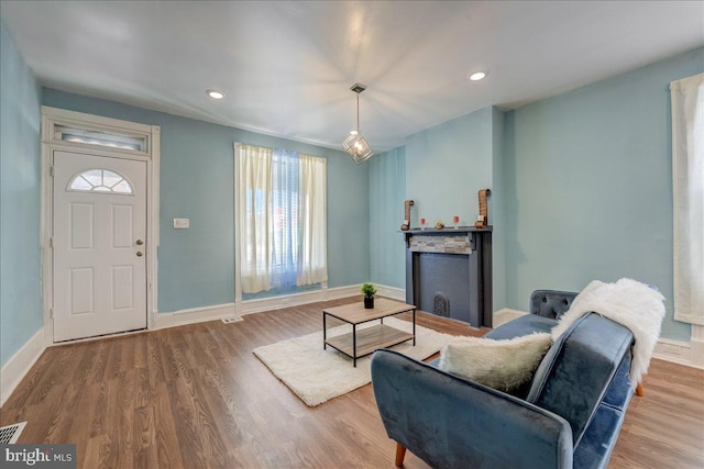 living area with visible vents, baseboards, wood finished floors, and recessed lighting