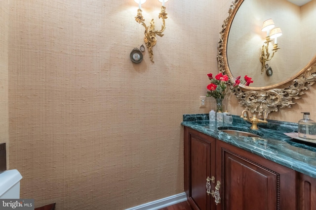 bathroom featuring vanity and toilet