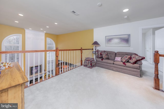 living area featuring carpet floors, visible vents, and recessed lighting