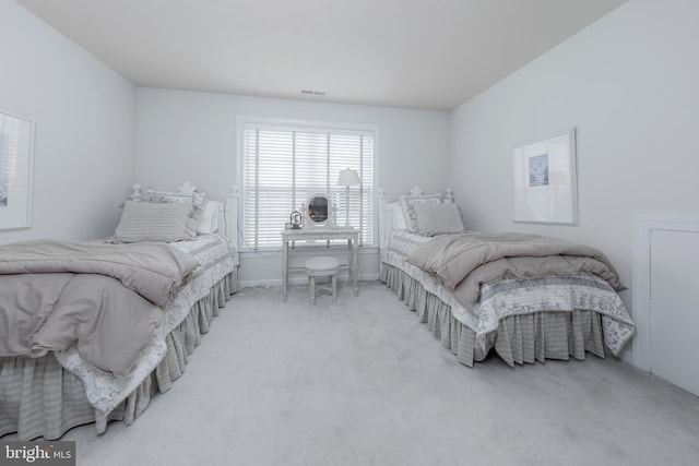 carpeted bedroom featuring visible vents