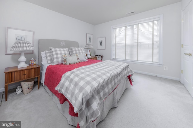 carpeted bedroom with baseboards and visible vents