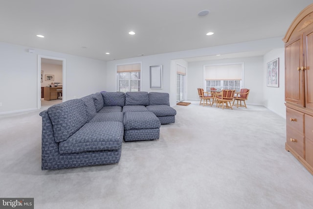 carpeted living area with baseboards, a healthy amount of sunlight, and recessed lighting