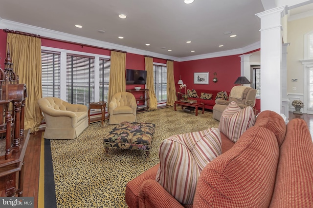 living area featuring recessed lighting, decorative columns, crown molding, and wood finished floors