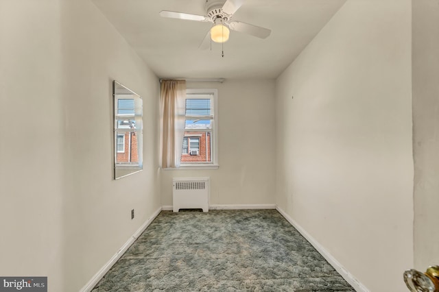 carpeted empty room featuring baseboards, ceiling fan, and radiator