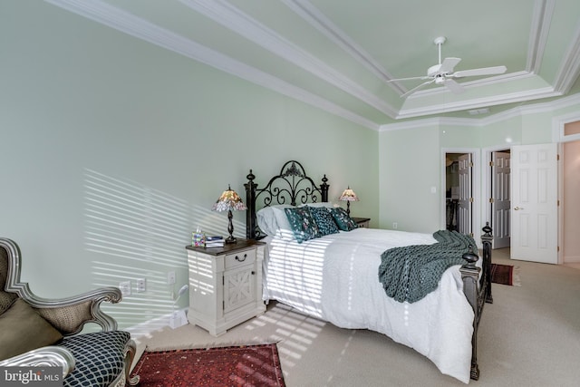 bedroom featuring ornamental molding, light colored carpet, ceiling fan, and a spacious closet