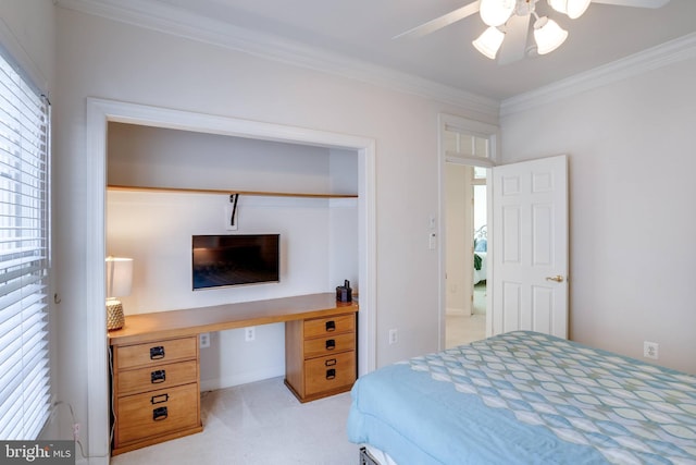 bedroom featuring ornamental molding, light colored carpet, baseboards, and a ceiling fan