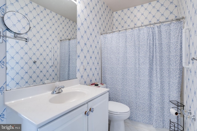 full bath featuring tile patterned flooring, vanity, and toilet