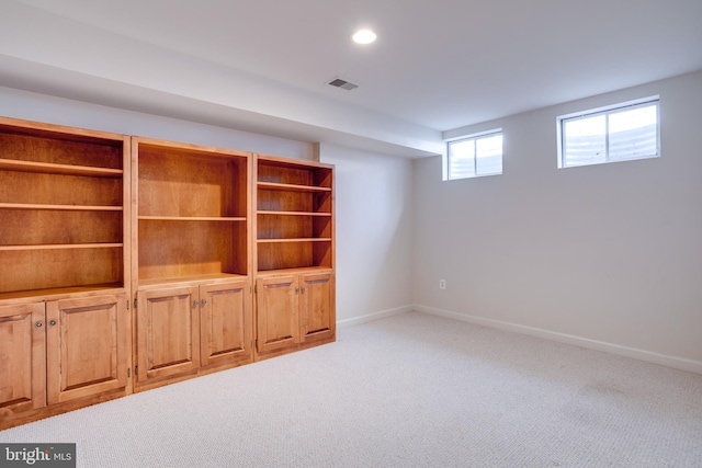 interior space with light carpet, recessed lighting, visible vents, and baseboards