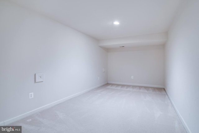 unfurnished room featuring recessed lighting, baseboards, and light colored carpet