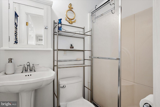 full bath with a stall shower, a sink, and toilet