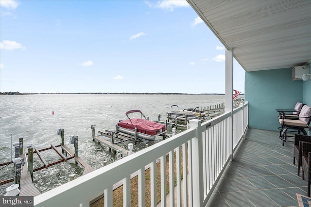 balcony featuring a dock, a water view, and boat lift