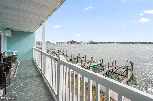 balcony featuring a water view, boat lift, and a dock