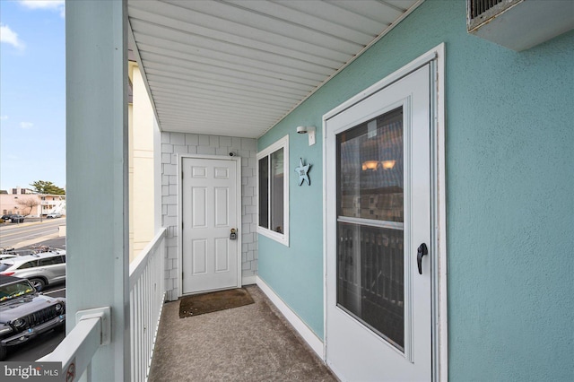 view of exterior entry featuring stucco siding