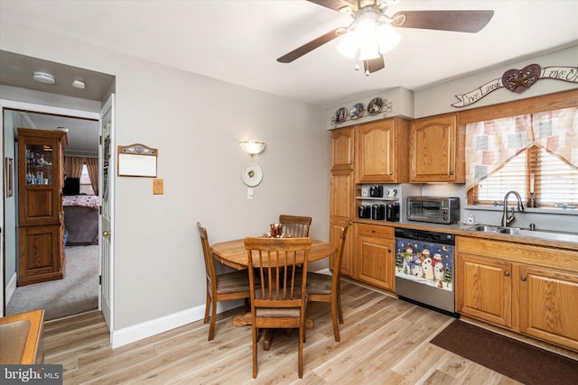 kitchen with ceiling fan, a toaster, a sink, light wood-style floors, and dishwasher