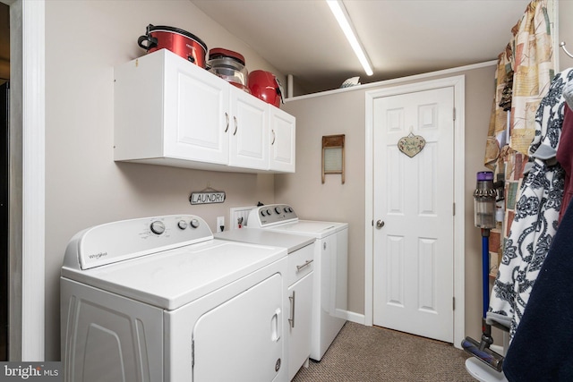 clothes washing area with cabinet space, carpet flooring, and independent washer and dryer