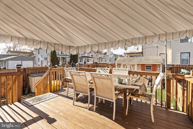 wooden deck featuring outdoor dining area and fence