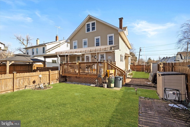 rear view of property featuring a chimney, a fenced backyard, a yard, and a deck