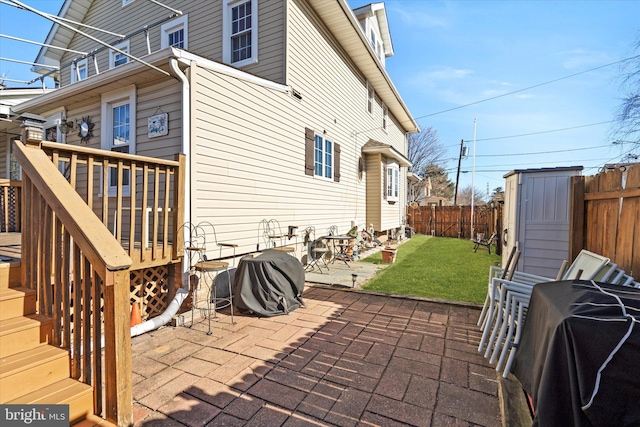 exterior space featuring stairs, a shed, an outdoor structure, and a fenced backyard