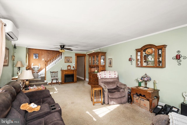 living area featuring ceiling fan, carpet flooring, ornamental molding, stairway, and a wall mounted air conditioner