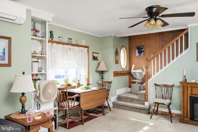 dining area featuring a glass covered fireplace, a wall unit AC, stairs, crown molding, and carpet floors