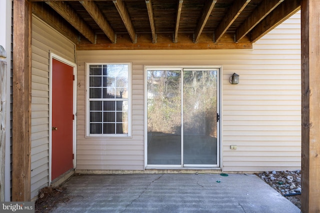 view of exterior entry featuring a patio area